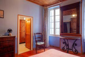 a bedroom with a table and a chair and a mirror at Maison à Sigean in Sigean
