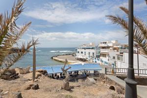 a view of a beach with buildings and the ocean at La Casa Bianco in El Cotillo