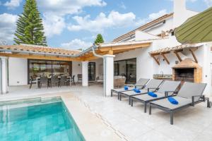 a patio with a swimming pool and a house at Villa Ana Puerto Pollensa in El Port