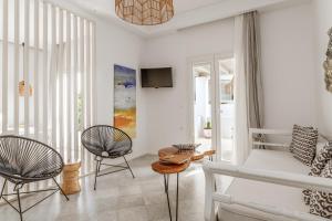 a living room with two chairs and a couch at Aeolos Thalia Suite in Agkidia