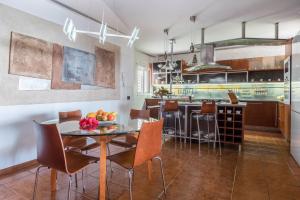 a kitchen with a table and chairs in a room at Spr Ático in Santa Úrsula
