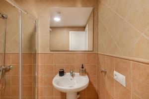 a bathroom with a sink and a mirror at Vv Timón in Puerto de Mogán +18 photos