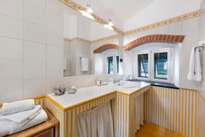 a bathroom with a sink and a mirror at Casa Marcone in Moneglia +28 photos