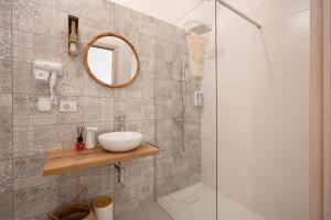 a bathroom with a sink and a shower at Dimora Giulia Luxury Suite and Room in Castellana Grotte