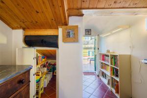 a kitchen and dining room with bookshelves at Casa Marcone in Moneglia