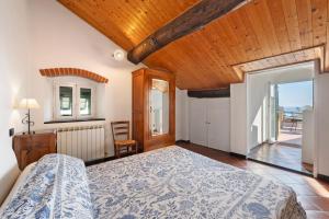 a bedroom with a bed and a wooden ceiling at Casa Marcone in Moneglia