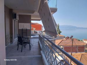 a balcony with a table and a view of the water at Menidi Sea View 302 in Menídion