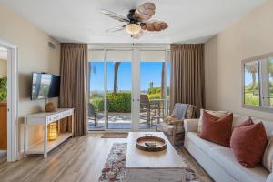 a living room with a couch and a ceiling fan at Gulf Front condo with Beach access and shared Pool in Fort Walton Beach