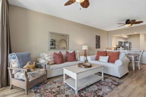 a living room with a couch and a table at Gulf Front condo with Beach access and shared Pool in Fort Walton Beach