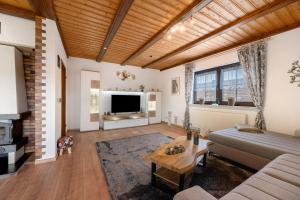 a living room with a couch and a tv at Betty’s Home in Gersheim