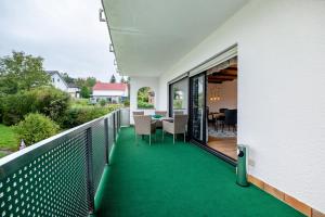 a balcony with green carpeting on a house at Betty’s Home in Gersheim