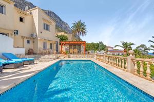 a swimming pool in the backyard of a villa at Adriana in Denia