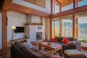 a living room with a couch and a fireplace at Ecolgica Casa Del Sol 1 in Navacepeda de Tormes