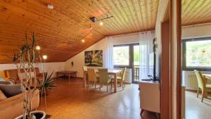 a living room with a table and a dining room at Fewo Jörges in Obernhausen