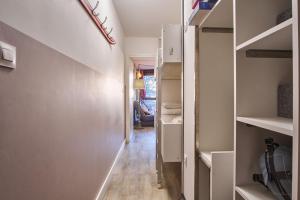 a hallway with white walls and wooden floors at Studio pied des pistes - Villard in Villard-de-Lans
