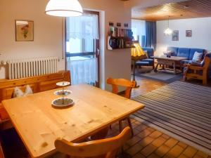 a living room with a wooden table and chairs at Haus Titisee in Löffingen