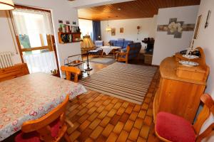a living room with a table and a dining room at Haus Titisee in Löffingen +29 photos