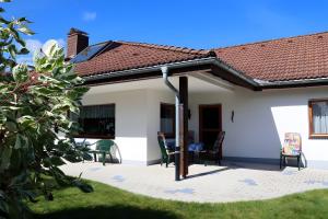a patio of a house with a roof at Haus Titisee in Löffingen