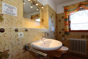 a bathroom with a sink and a toilet and a mirror at Haus Titisee in Löffingen