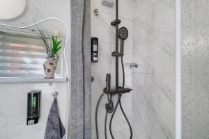 a shower with a shower head in a bathroom at Museum View, vista sul museo in Sassello