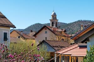 a village with a clock tower in the background at Museum View, vista sul museo in Sassello