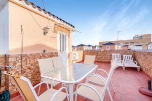 a patio with a white table and chairs at Verano Azul in La Mata