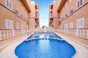 a swimming pool in the middle of a building at Verano Azul in La Mata
