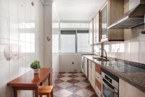 a kitchen with a counter and a table in it at Apartamento Faro de Barbate in Barbate +13 photos