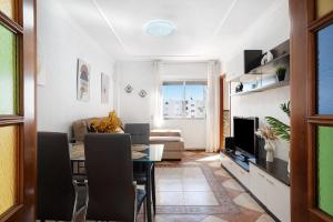 a living room with a table and a couch at Apartamento Faro de Barbate in Barbate