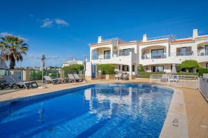 a large house with a swimming pool in front of it at Norah’s House in Carvoeiro