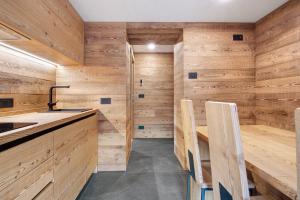 a sauna with wooden walls and a sink at Agriturismo Montespluga in Madesimo +45 photos