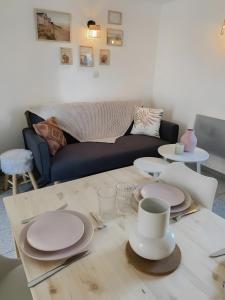 a living room with a table with plates on it at Escapade Pirouaise - la Salicorne in Pirou