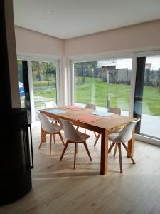 a wooden table and chairs in a room at Loewe Bad Frankenhausen in Bad Frankenhausen