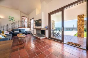 a living room with a couch and a fireplace at Villa Ulivi 10 in Is Molas 