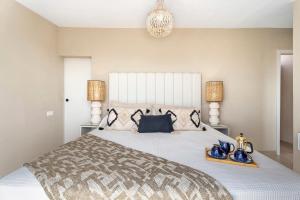 a bedroom with a large bed and two lamps at Fantastic Villa Verano in San Miguel de Abona +34 photos