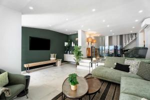 a living room with a couch and a table at Fantastic Villa Verano in San Miguel de Abona