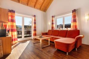a living room with a couch and a table at Obst- Und Ferienhof Brudy in Appenweier
