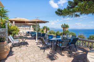 a patio with a table and chairs and the ocean at Stefanos place Studio sea View 7 in Corfu