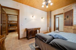 a bedroom with a bed and a wooden ceiling at Mas del Vedell in L'Ampolla +24 photos
