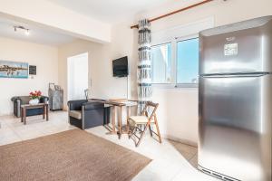 a kitchen with a stainless steel refrigerator and a table at Green Pearl in Lachania