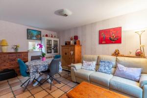 a living room with a couch and a table at Maison mitoyenne proche lac annecy in Annecy-le-Vieux