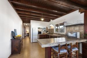 a kitchen with a counter and a refrigerator at Almar in Tinajo