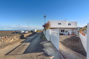 an empty road in front of a building at Almar in Tinajo