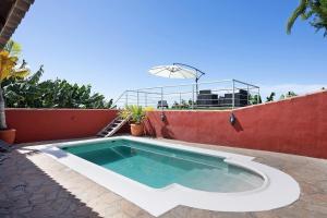 a swimming pool on the side of a house at Casa La Flamenca in Tijarafe