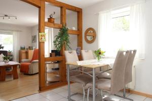 a kitchen and living room with a table and chairs at Ferienwohnung Marianne in Olsberg
