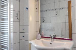 a bathroom with a sink and a mirror at Ferienwohnung Marianne in Olsberg