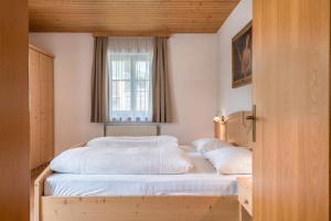 a bedroom with two beds and a window at Haus Thurn Apartment A in Castelrotto