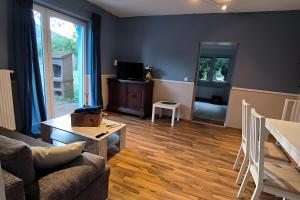 a living room with a couch and a table at Ferienwohnung Naturglück in Sundhagen-Niederhof
