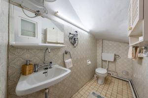 a bathroom with a sink and a toilet at Villa Marianthi-kaizer Bridge in Achílleion +24 photos