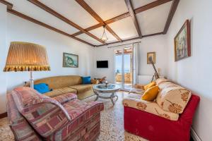 a living room with two couches and a table at Villa Marianthi-kaizer Bridge in Achílleion